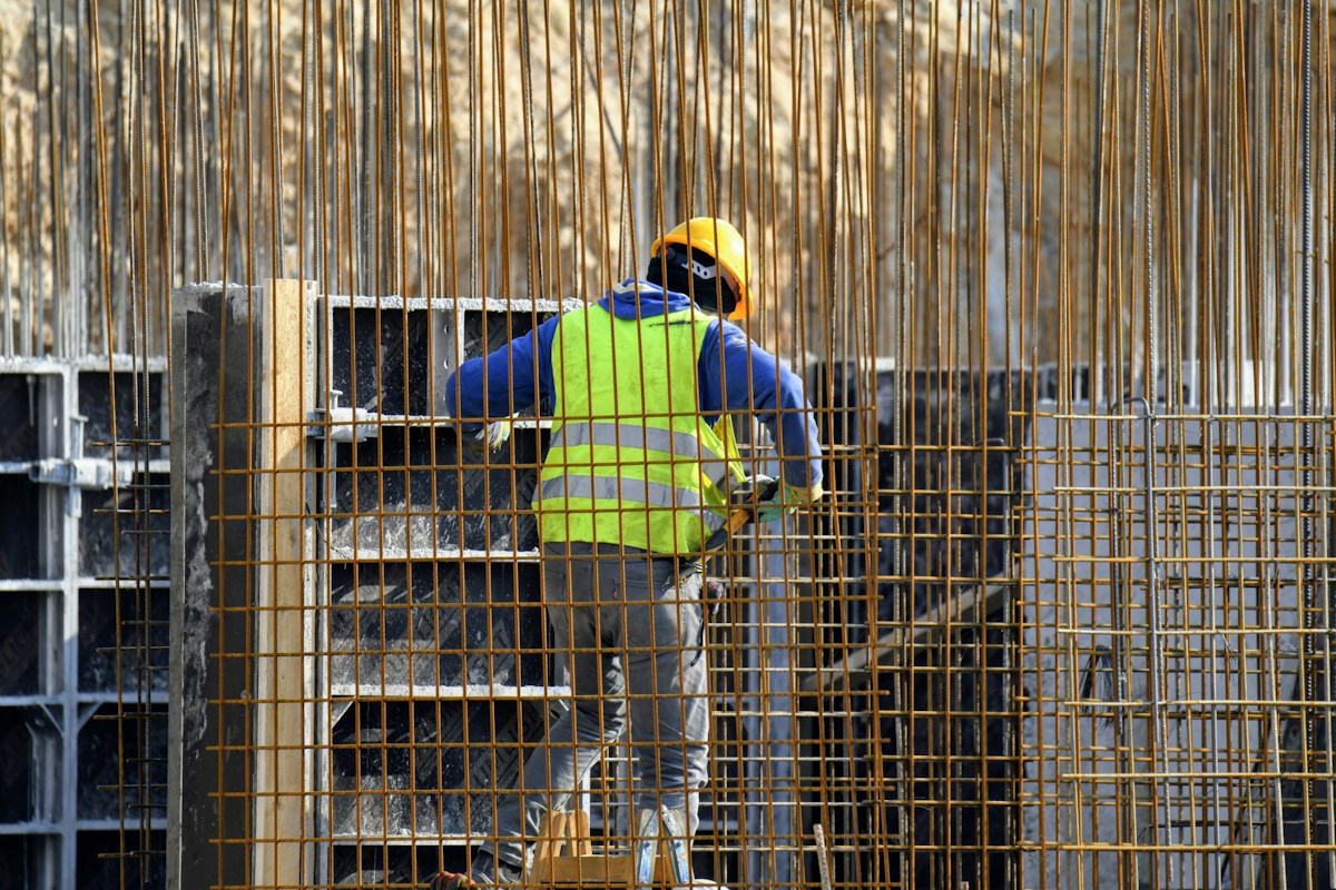 Construction worker setting up reinforced concrete forms